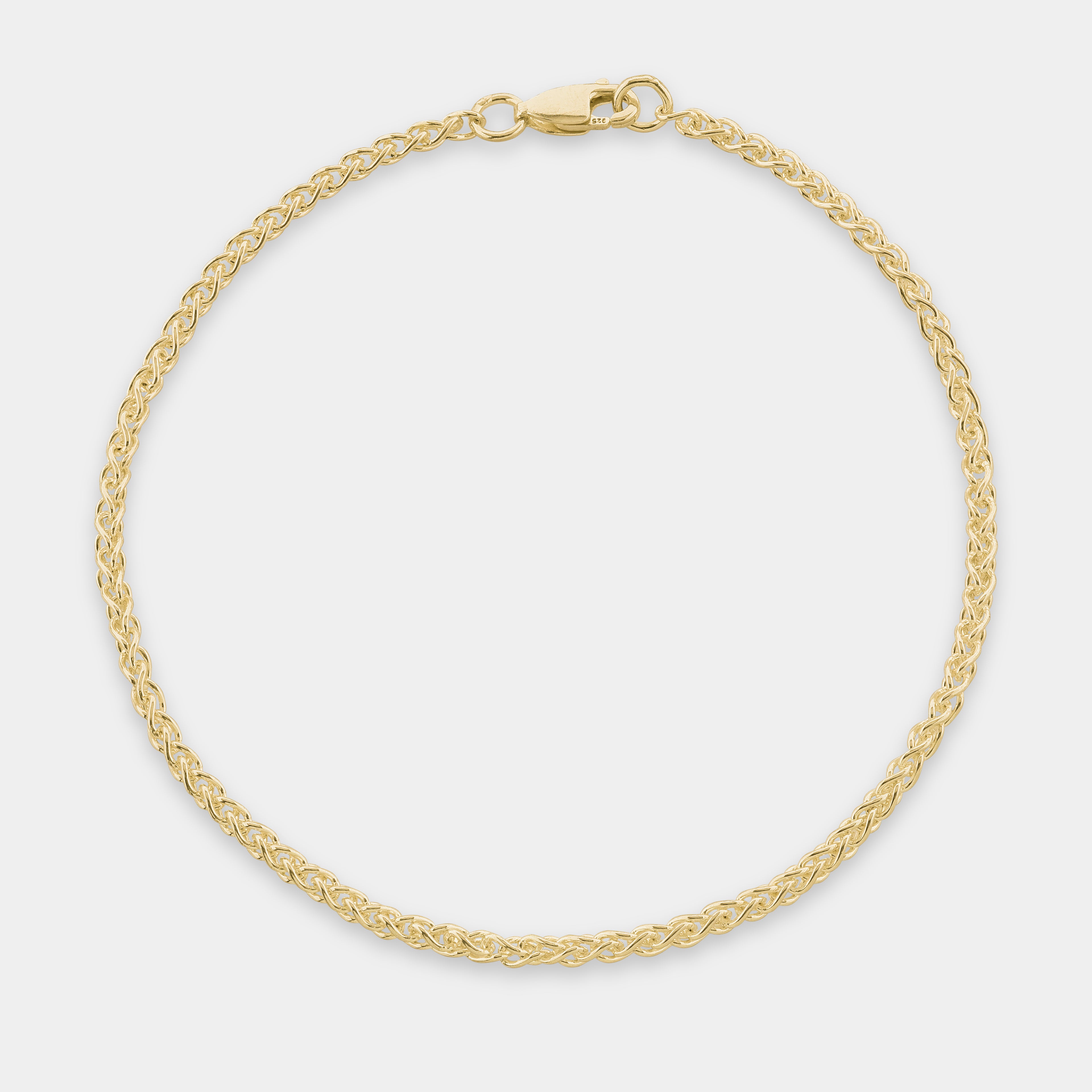 Gold Monarch Spiga bracelet on a light gray background