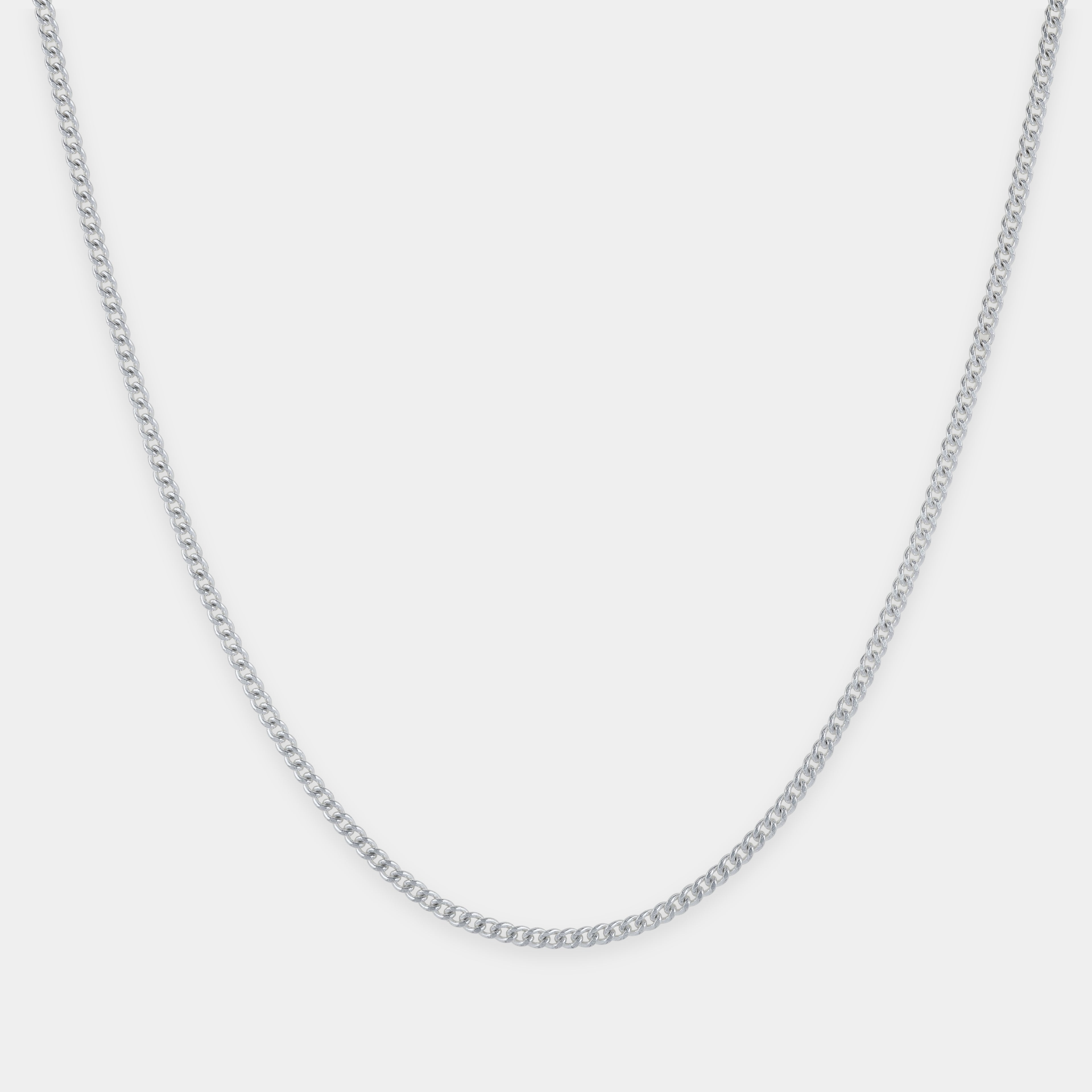 Silver chain necklace on a light gray background