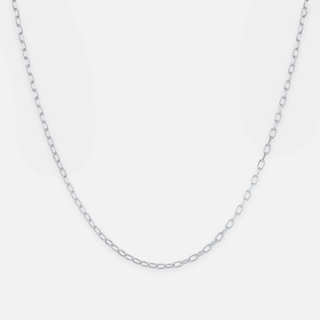 Silver chain necklace on a light gray background