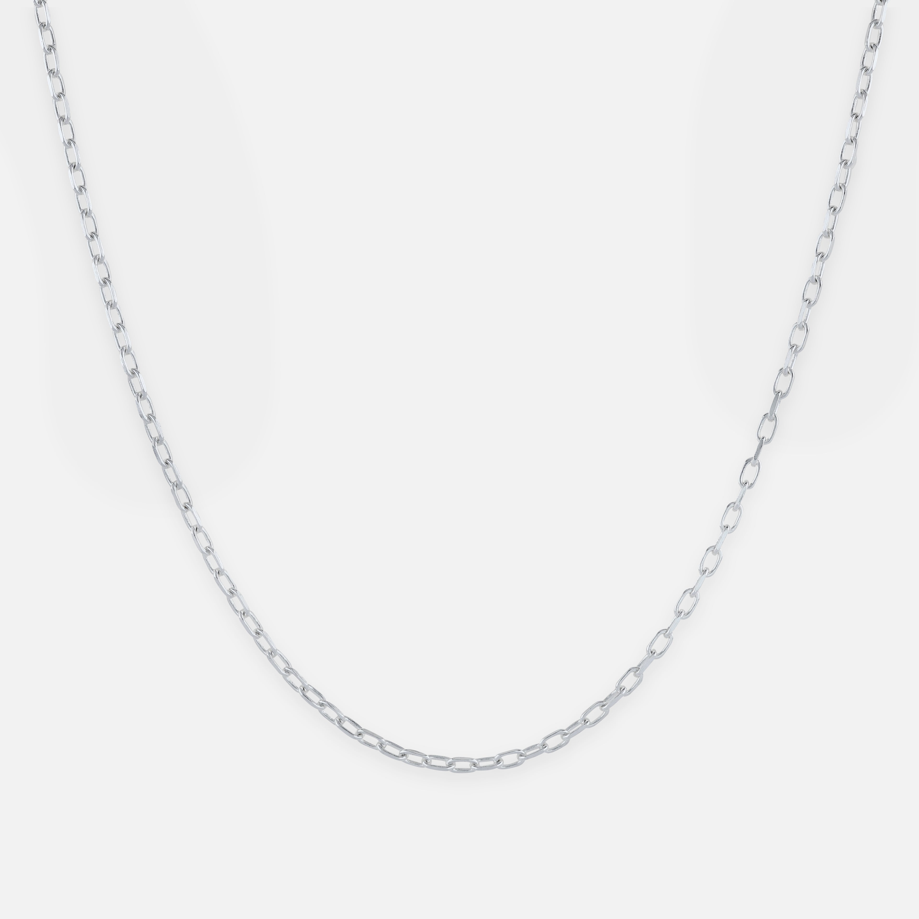 Silver chain necklace on a light gray background