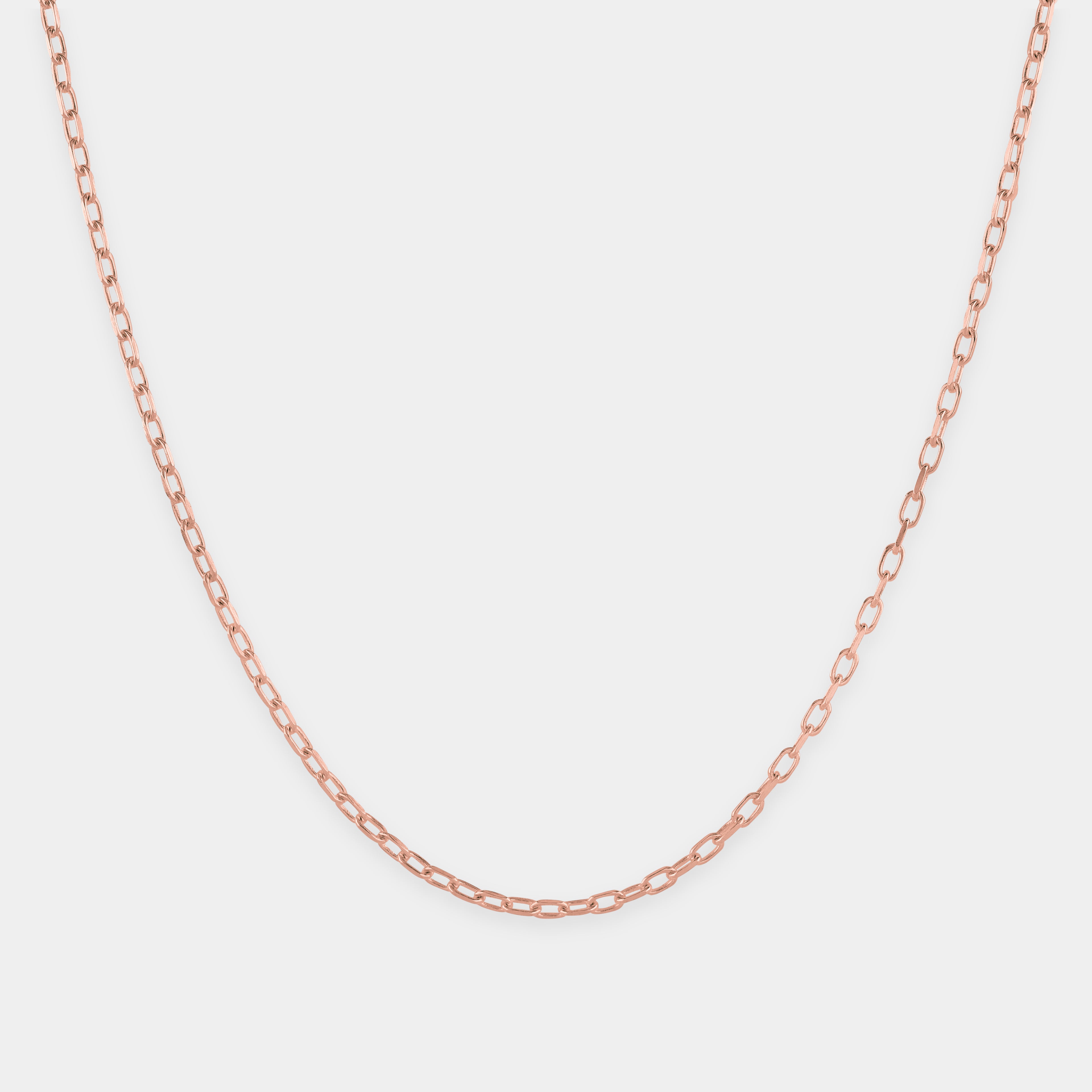 Rose gold chain on a light gray background