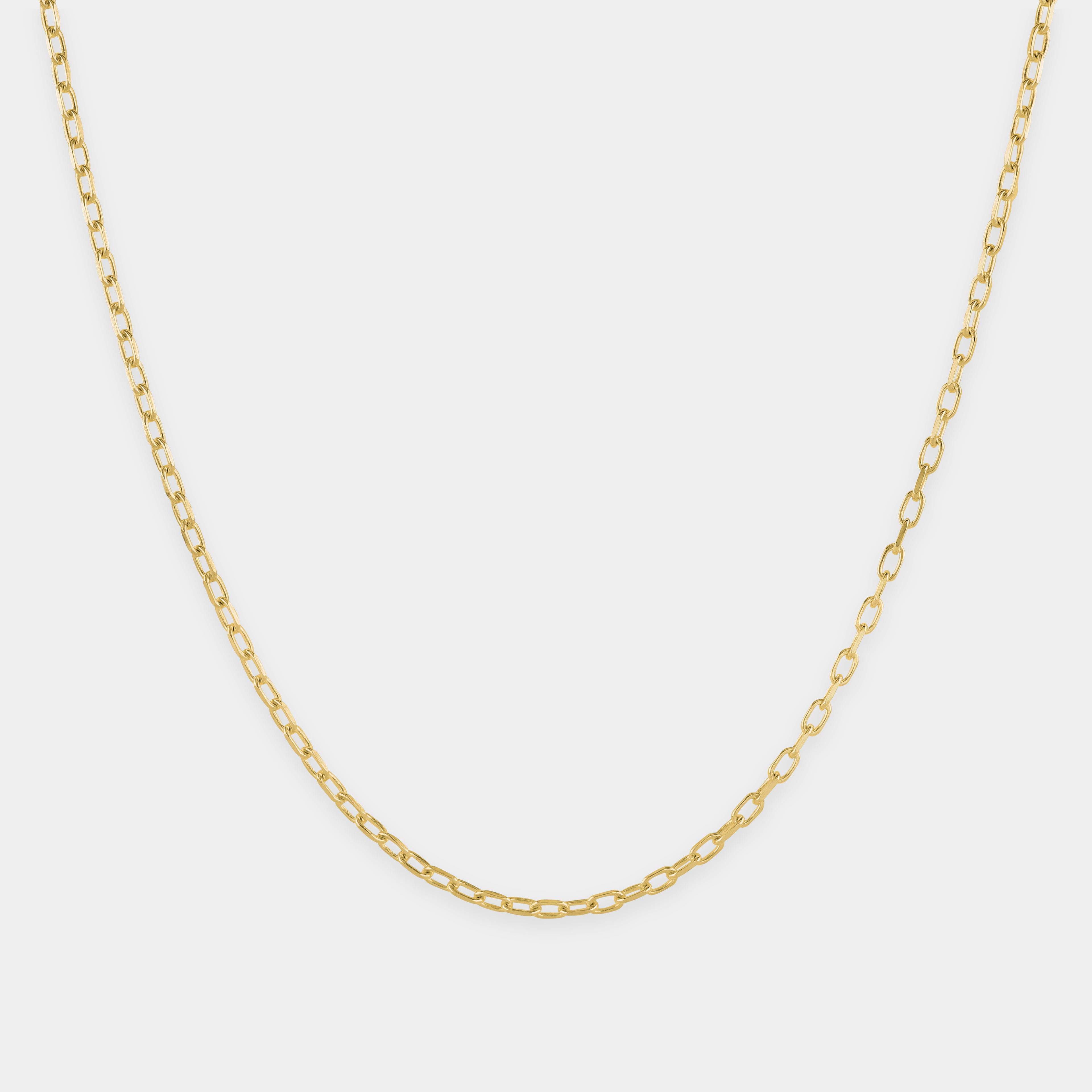 Gold chain necklace on a light gray background