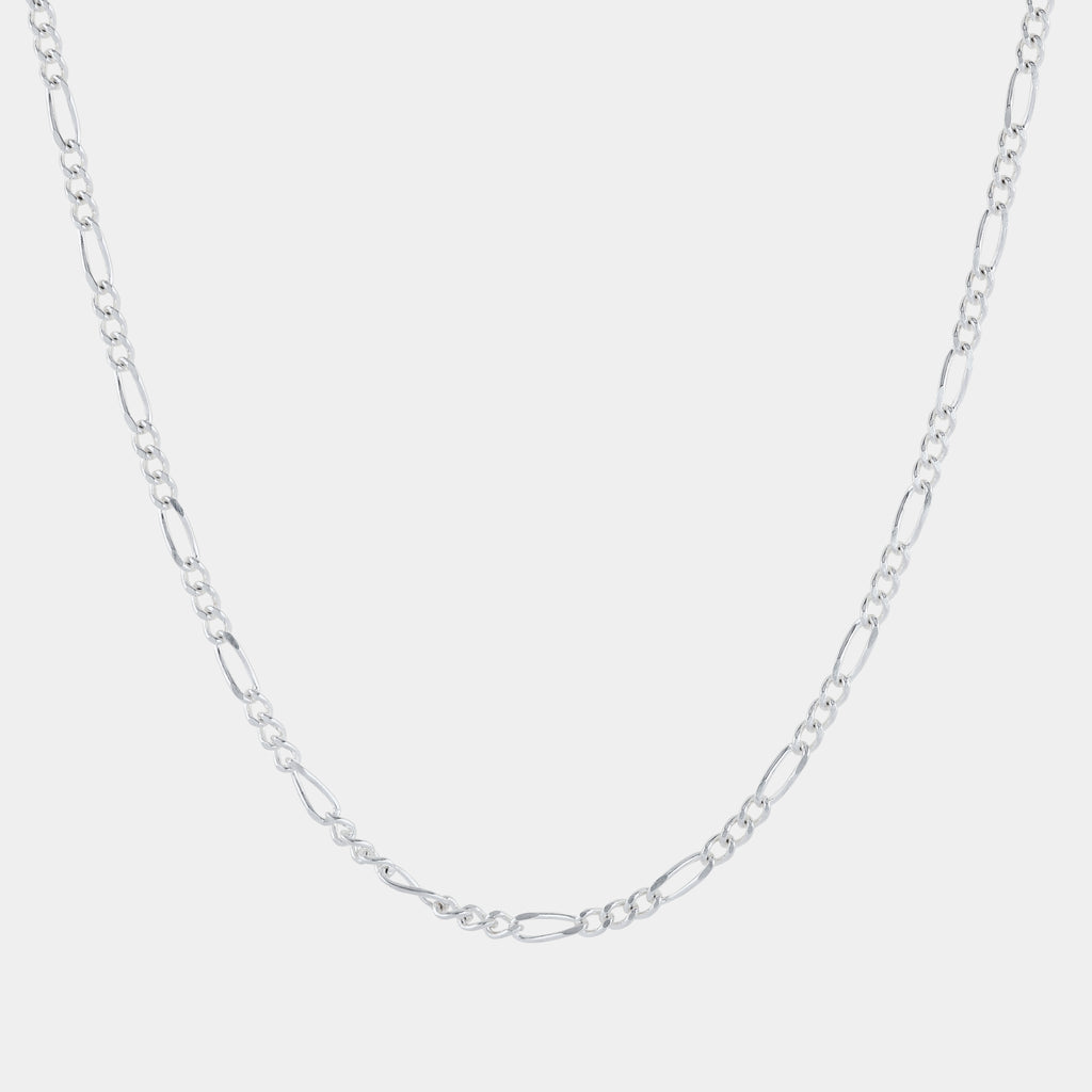 Silver chain necklace on a light gray background