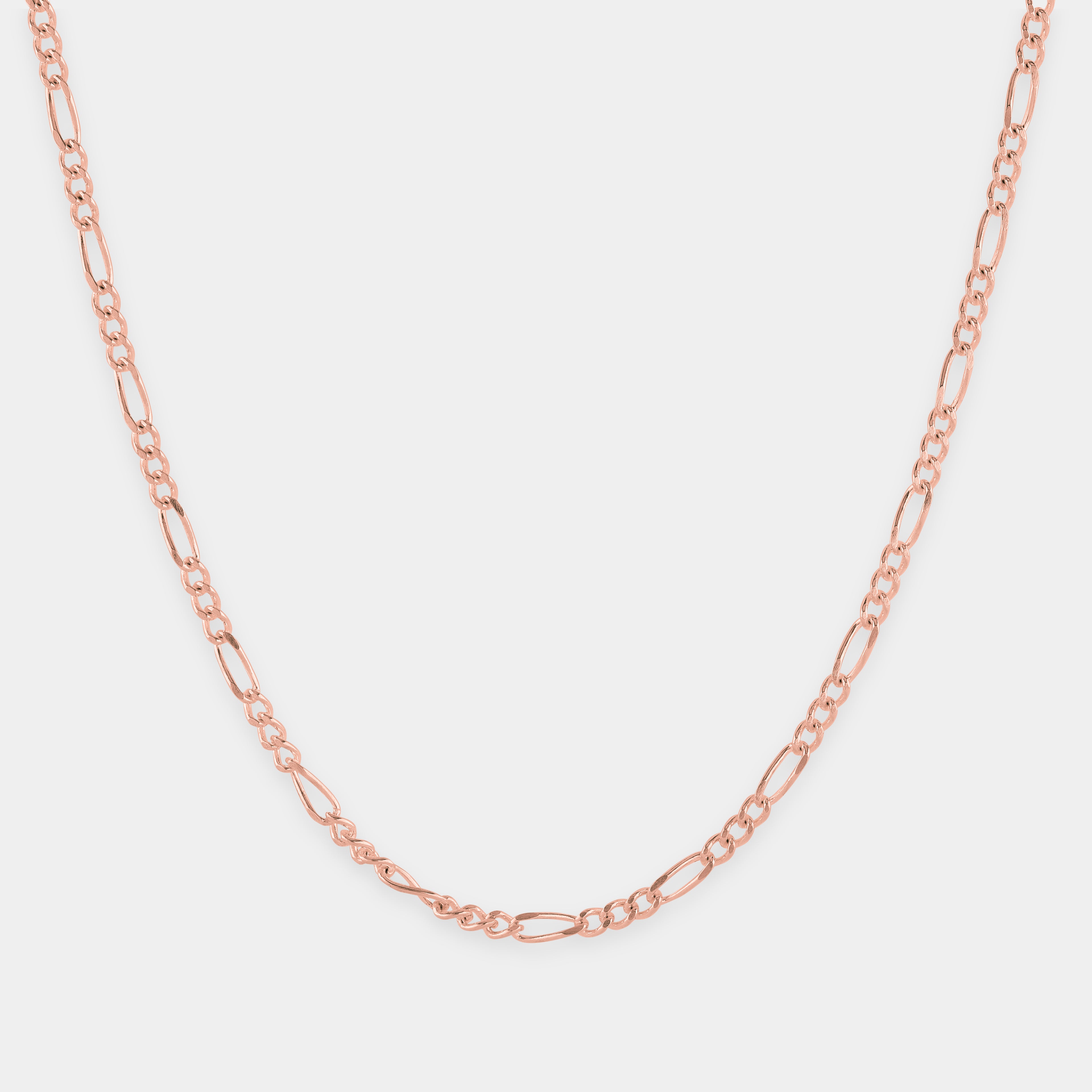 Rose gold chain necklace on a light gray background