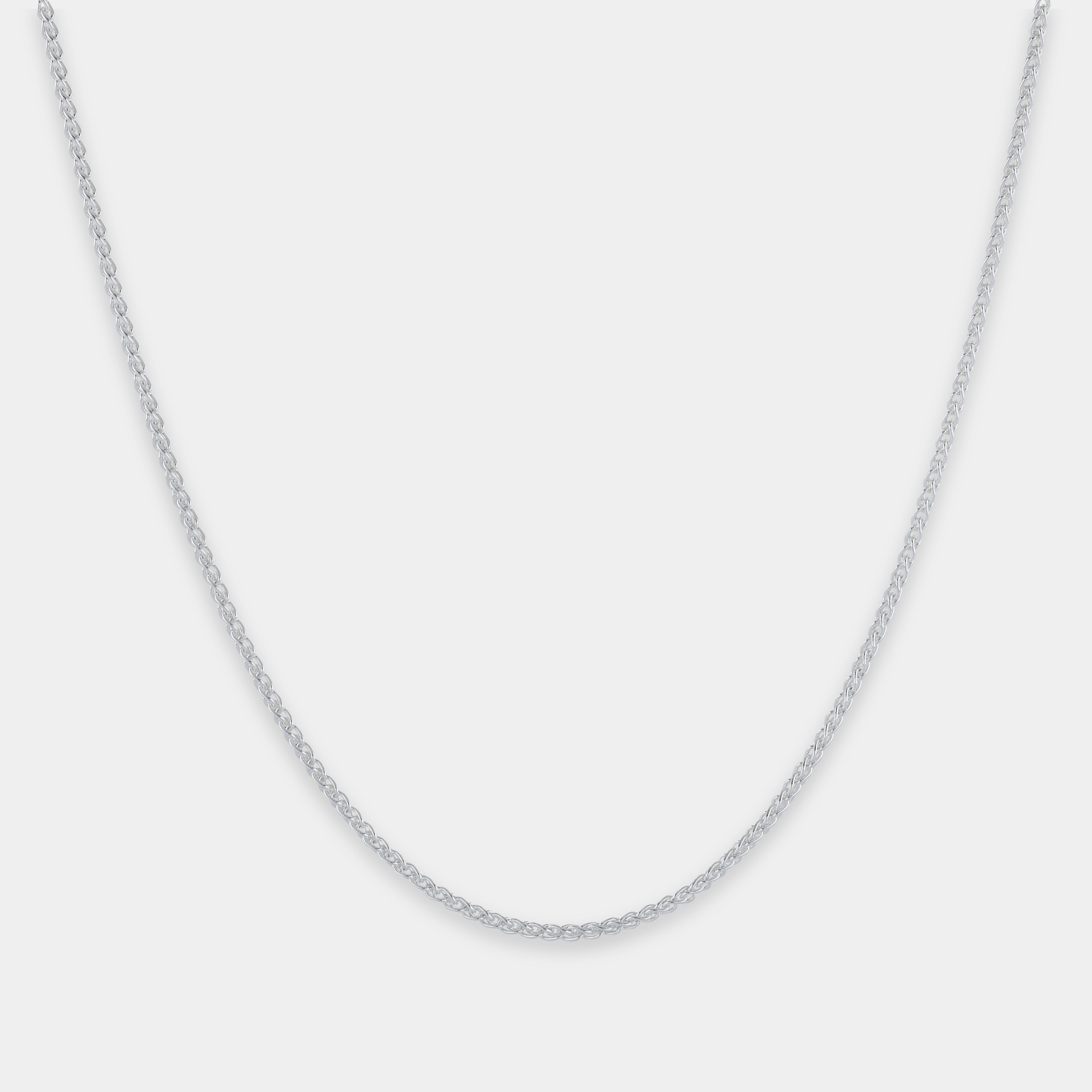 Silver chain necklace on a light gray background