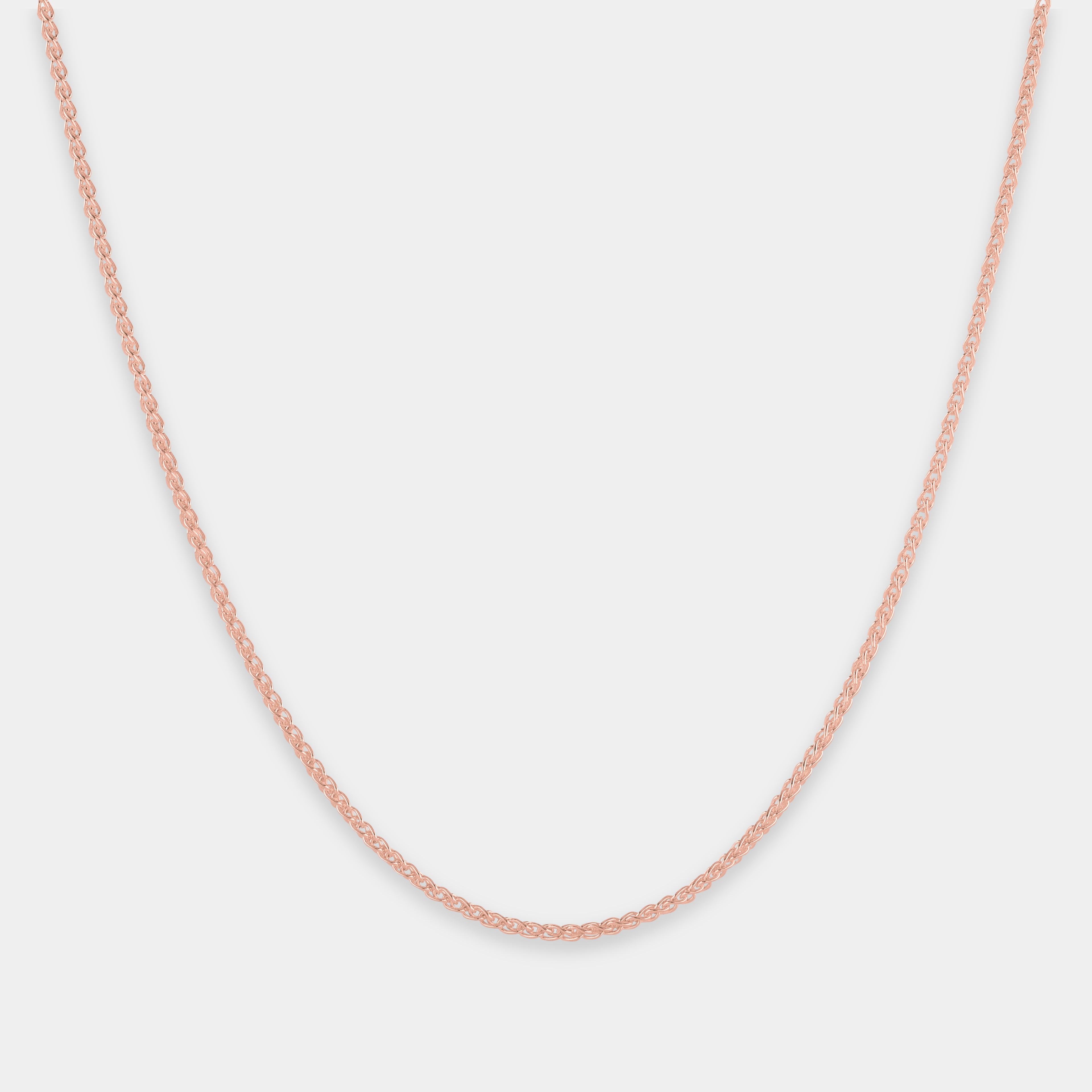 Rose gold chain on a light gray background