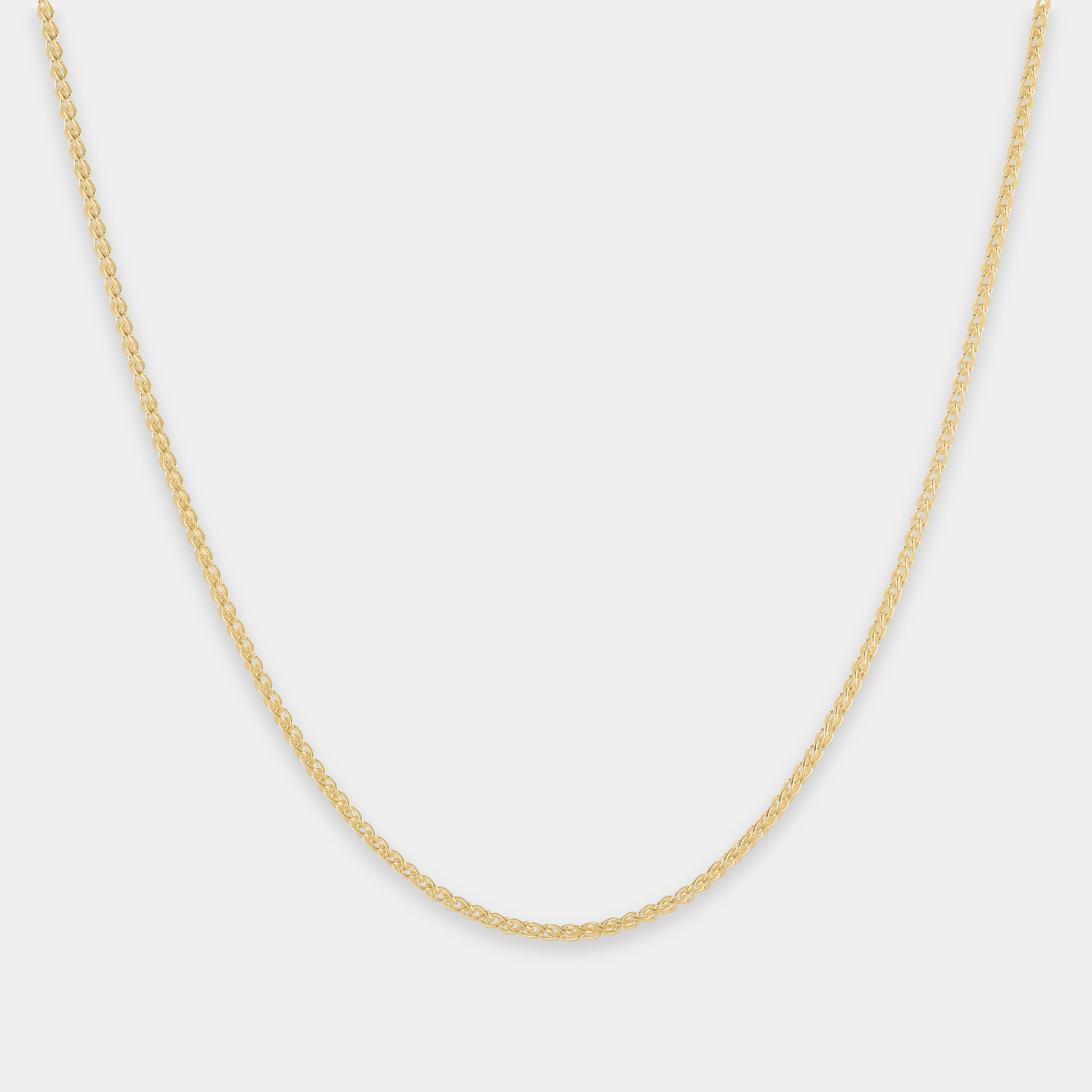 Gold chain necklace on a light gray background